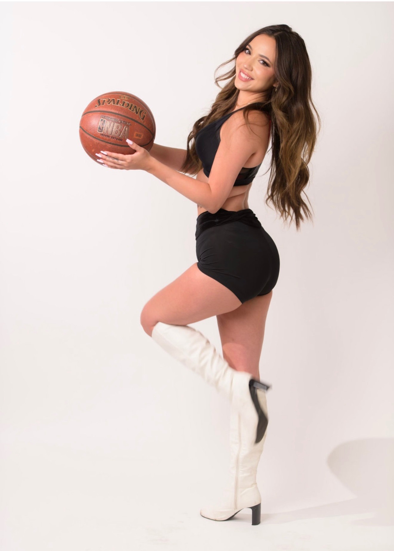 Bella in studio with an NBA basketball